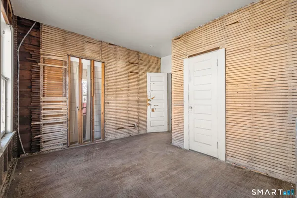an empty room with wooden door