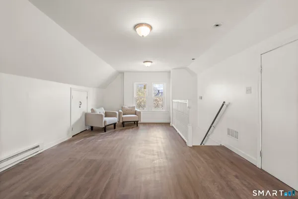 a kitchen with stainless steel appliances kitchen island granite countertop a refrigerator and a stove top oven
