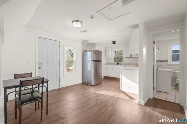 a kitchen with white cabinets and white appliances