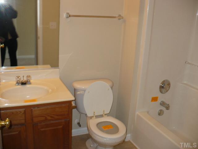 3406 Sosa Road Raleigh, NC 27610 - Photo 13 of 16 a bathroom with a sink a toilet and shower
