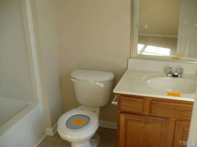 3406 Sosa Road Raleigh, NC 27610 - Photo 14 of 16 a bathroom with a sink and a toilet