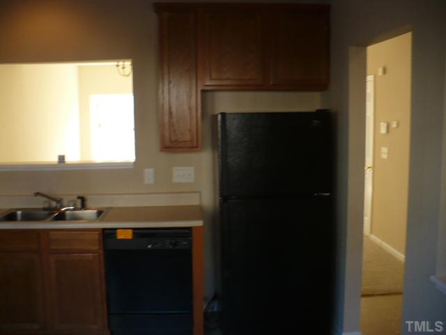 3406 Sosa Road Raleigh, NC 27610 - Photo 4 of 16 a kitchen with a sink a window and cabinets