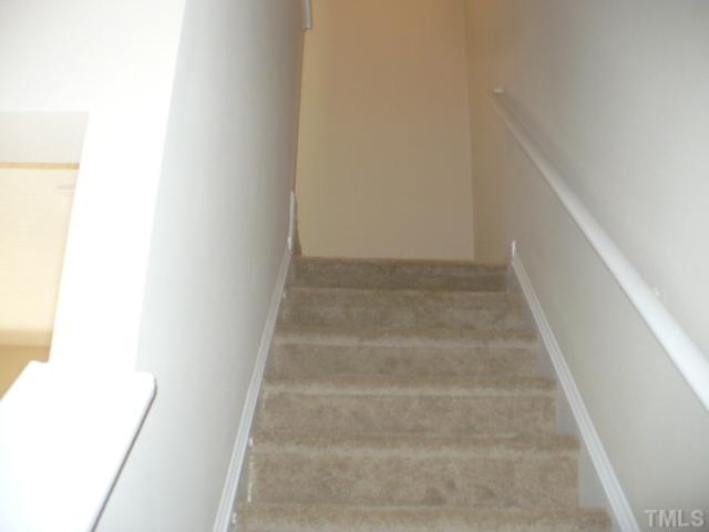 3406 Sosa Road Raleigh, NC 27610 - Photo 8 of 16 a view of staircase with white walls