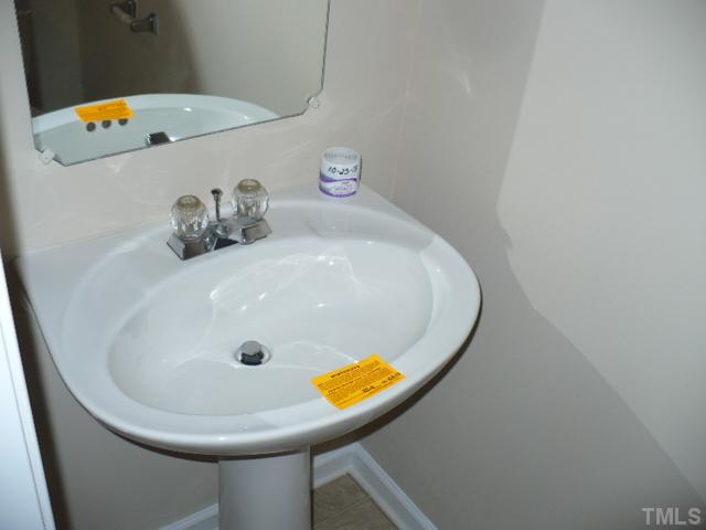 3406 Sosa Road Raleigh, NC 27610 - Photo 10 of 16 a bathroom with a sink and mirror