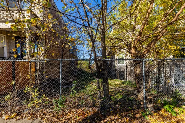 a backyard of a house with lots of plants and trees