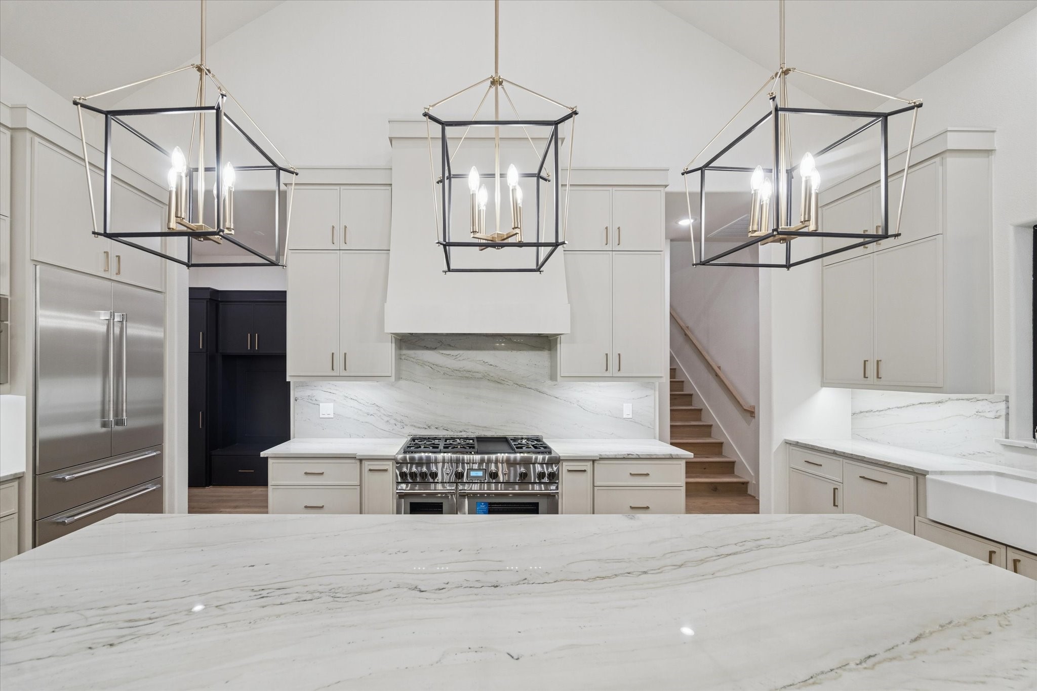 25179 Balmorhea Way Montgomery, TX 77316 - Photo 13 of 40 a kitchen with stainless steel appliances and white cabinets