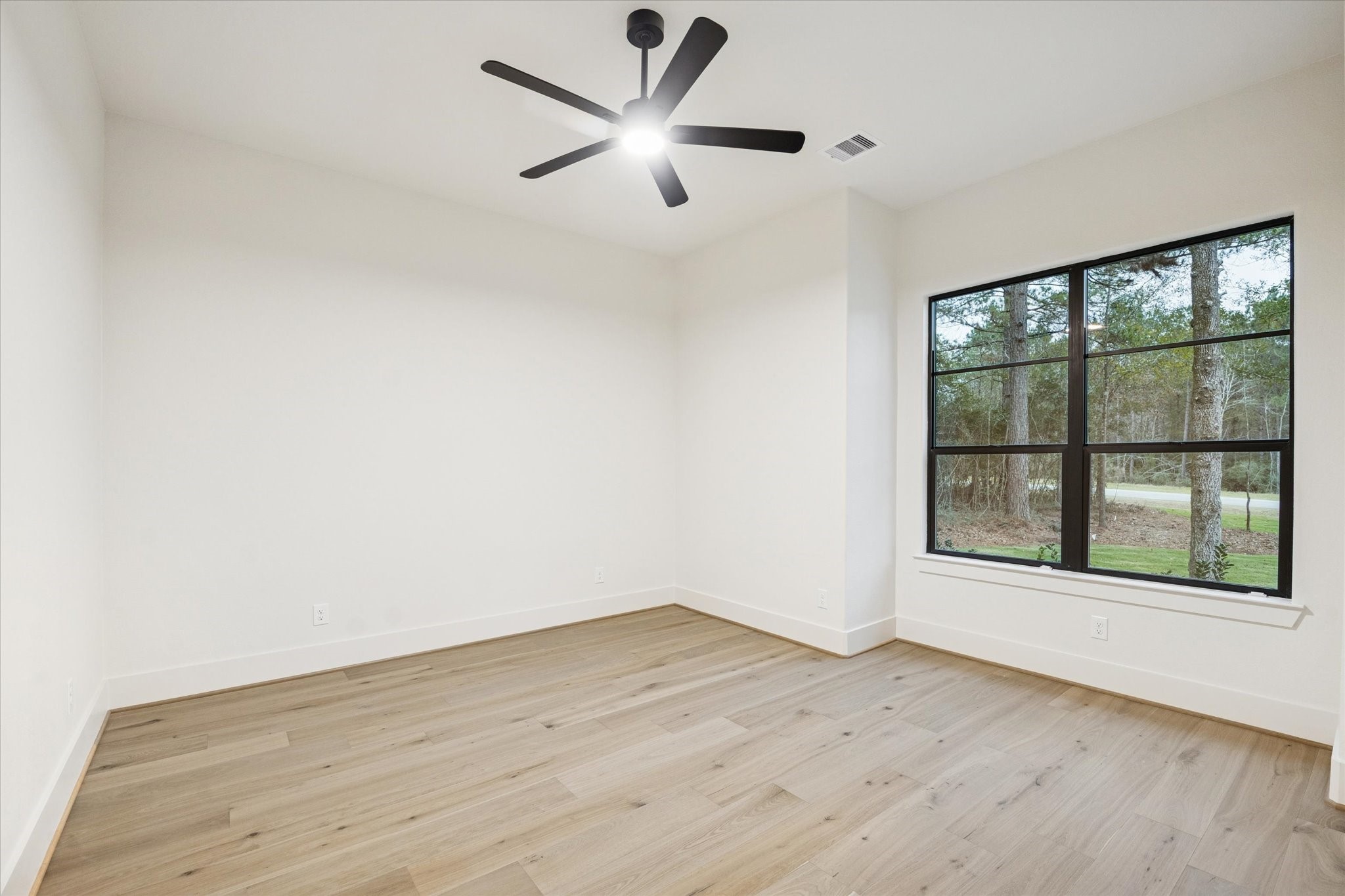 25179 Balmorhea Way Montgomery, TX 77316 - Photo 27 of 40 an empty room with wooden floor and windows