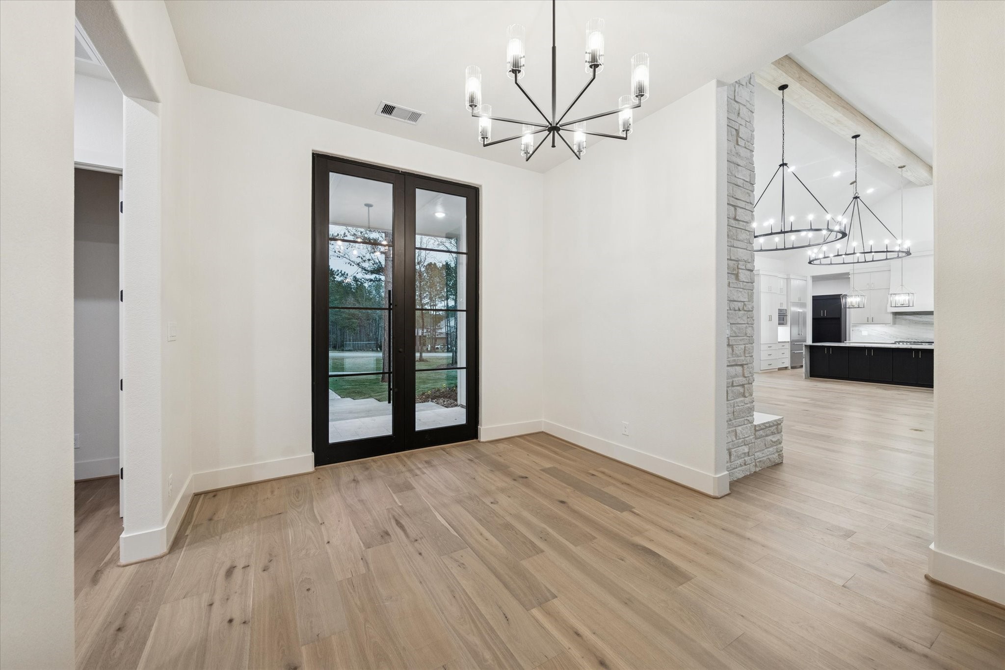 25179 Balmorhea Way Montgomery, TX 77316 - Photo 6 of 40 a view of an empty room with wooden floor and a window