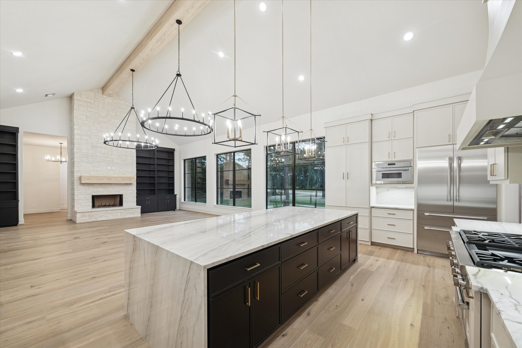 25179 Balmorhea Way Montgomery, TX 77316 - Photo 9 of 40 an open kitchen with a sink a counter space stainless steel appliances and cabinets