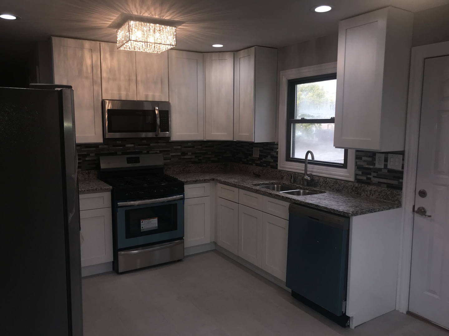 3710 147th Place Midlothian, IL 60445 - Photo 4 of 13 a kitchen with stainless steel appliances granite countertop a stove a sink and a refrigerator