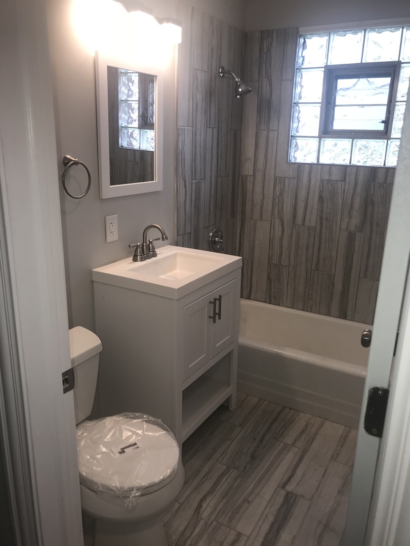 3710 147th Place Midlothian, IL 60445 - Photo 6 of 13 a bathroom with a sink a toilet a mirror and shower