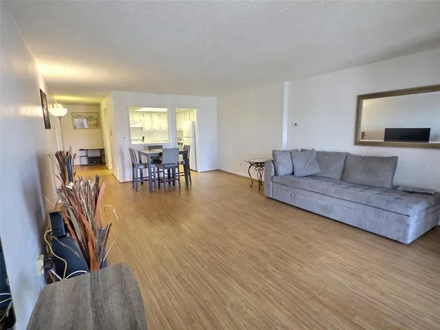 a kitchen with stainless steel appliances granite countertop a stove a sink and white cabinets