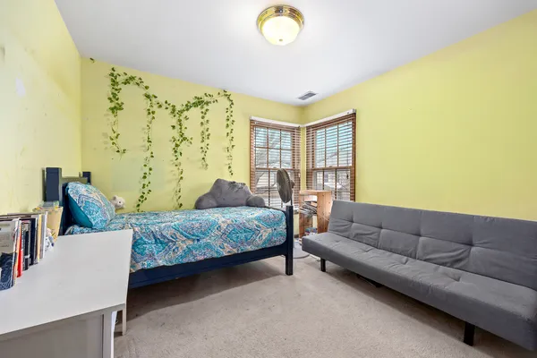 a bedroom with a bed and a couch