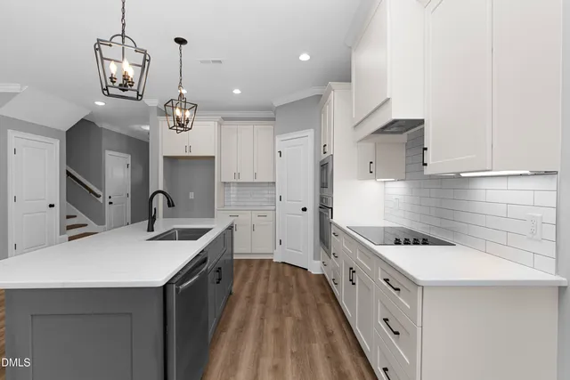 a kitchen with stainless steel appliances a sink stove and cabinets