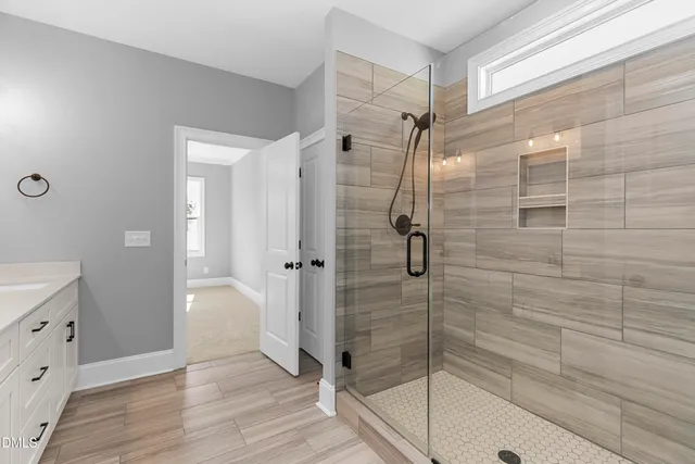 a bathroom with a glass shower door