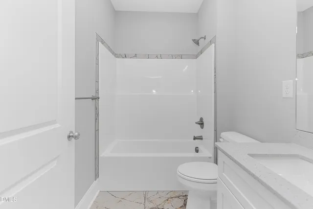 a bathroom with a toilet and a bath tub