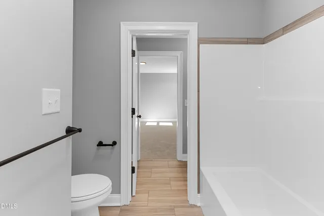 a bathroom with a granite countertop toilet and a shower