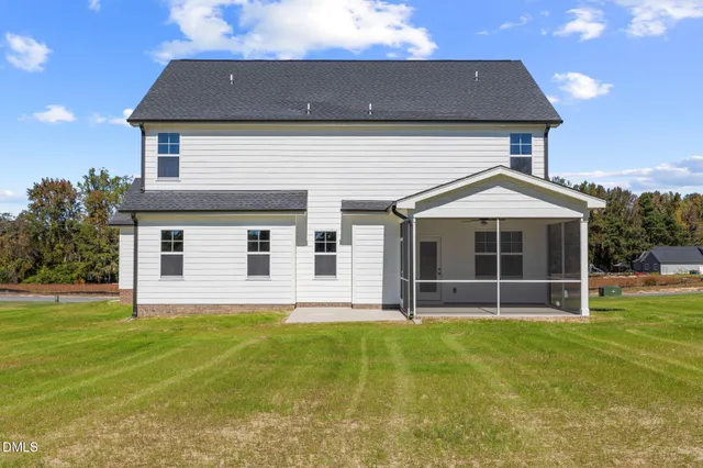 a view of a house with a yard and sitting area