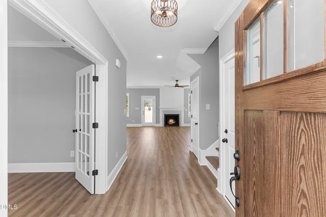 a view of a hallway with wooden floor and staircase