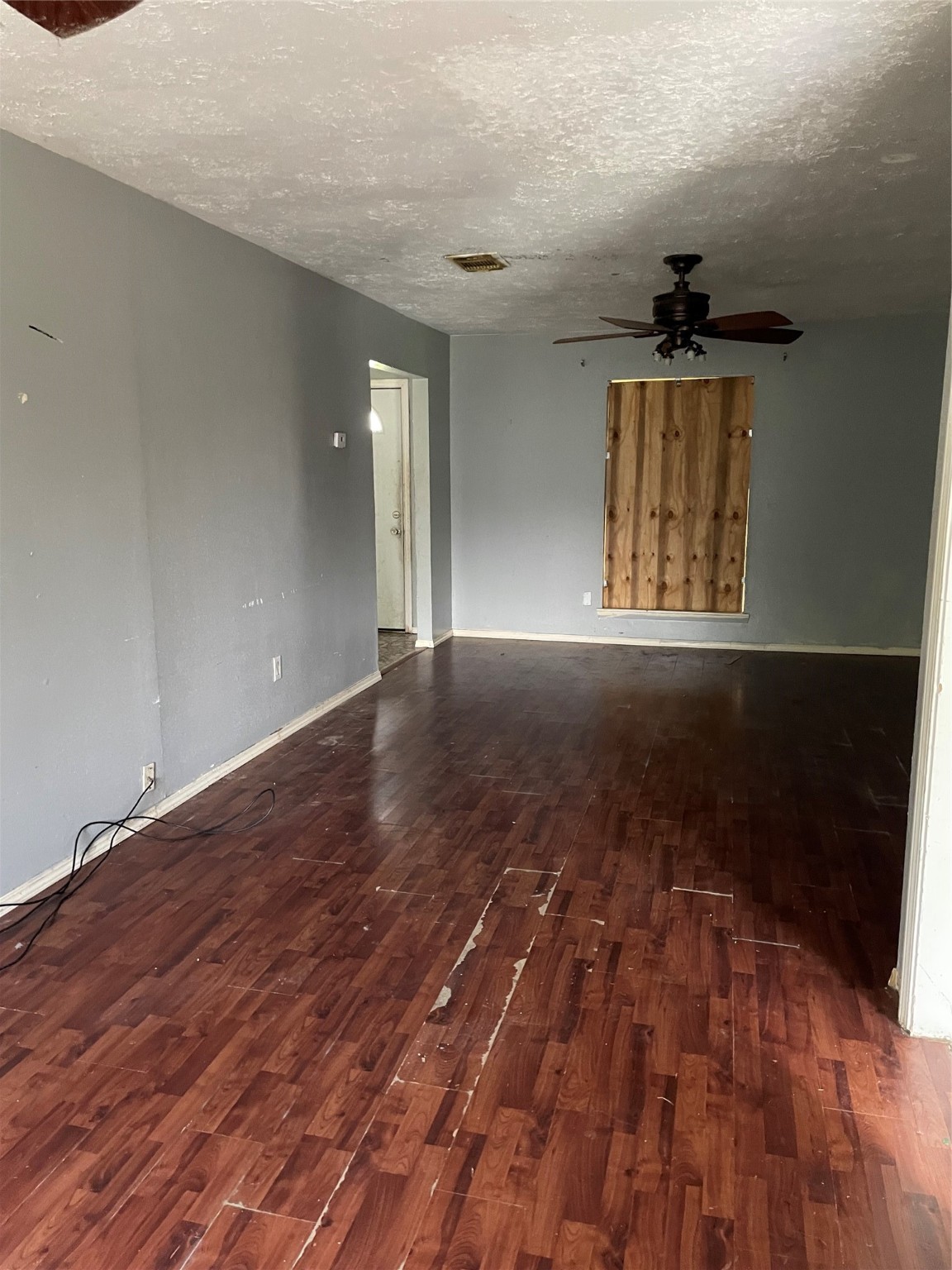 814 Deercrest Street Channelview, TX 77530 - Photo 5 of 14 wooden floor in an empty room with a window