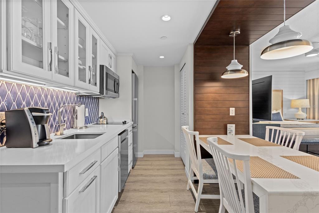 230 Sands Point Road, Unit 3205 Longboat Key, FL 34228 - Photo 14 of 38 a kitchen with a sink appliances and cabinets