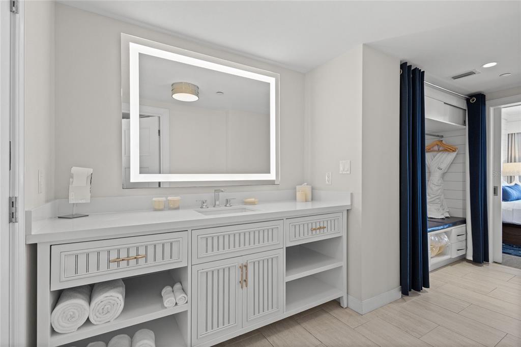 230 Sands Point Road, Unit 3205 Longboat Key, FL 34228 - Photo 18 of 38 a bathroom with a double vanity sink and a mirror