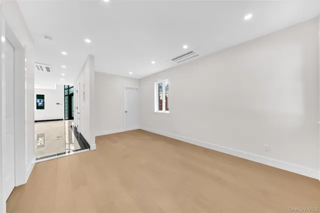 an empty room with entrance and windows