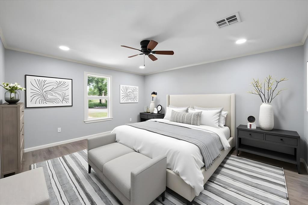 1009 North Spikes Road Corsicana, TX 75110 - Photo 12 of 31 a bedroom with bed and a chandelier