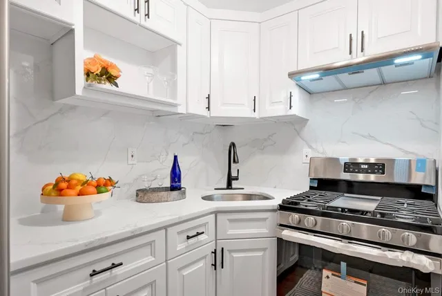 a kitchen with stainless steel appliances granite countertop a stove and a microwave