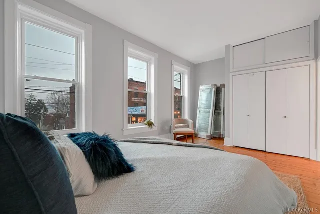 a bed room with a bed and a large window