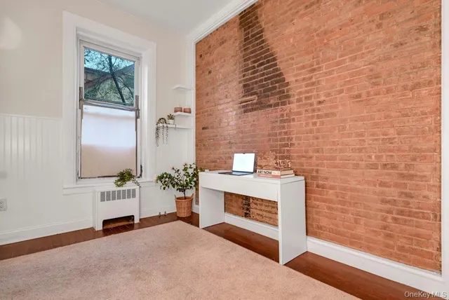 a view of an empty room with a fireplace and a window