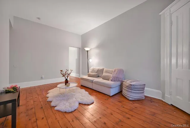 a bedroom with furniture and a wooden floor