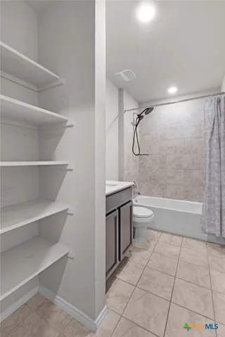 a bathroom with a shower a toilet and a shower