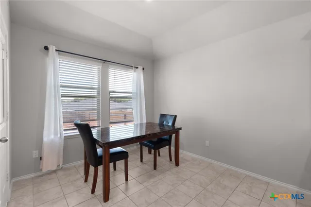 a view of a dining room with furniture and a window