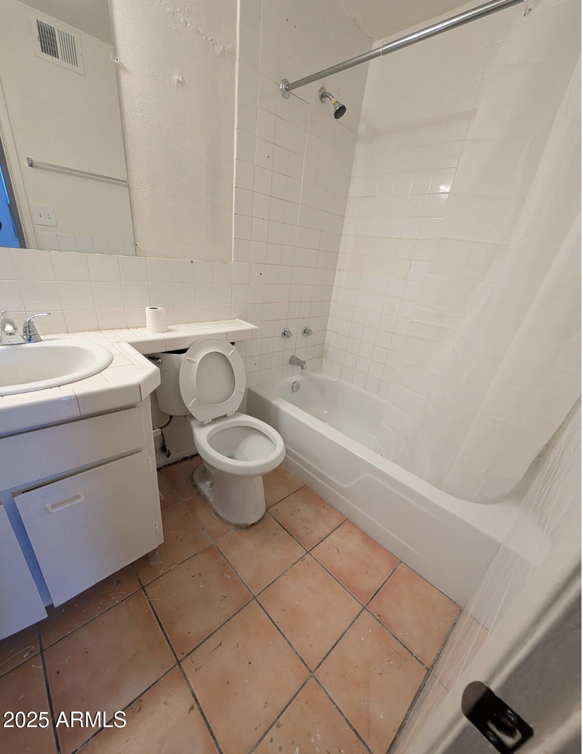 3302 East Thunderbird Road Phoenix, AZ 85032 - Photo 4 of 10 a white toilet sitting next to a bath tub