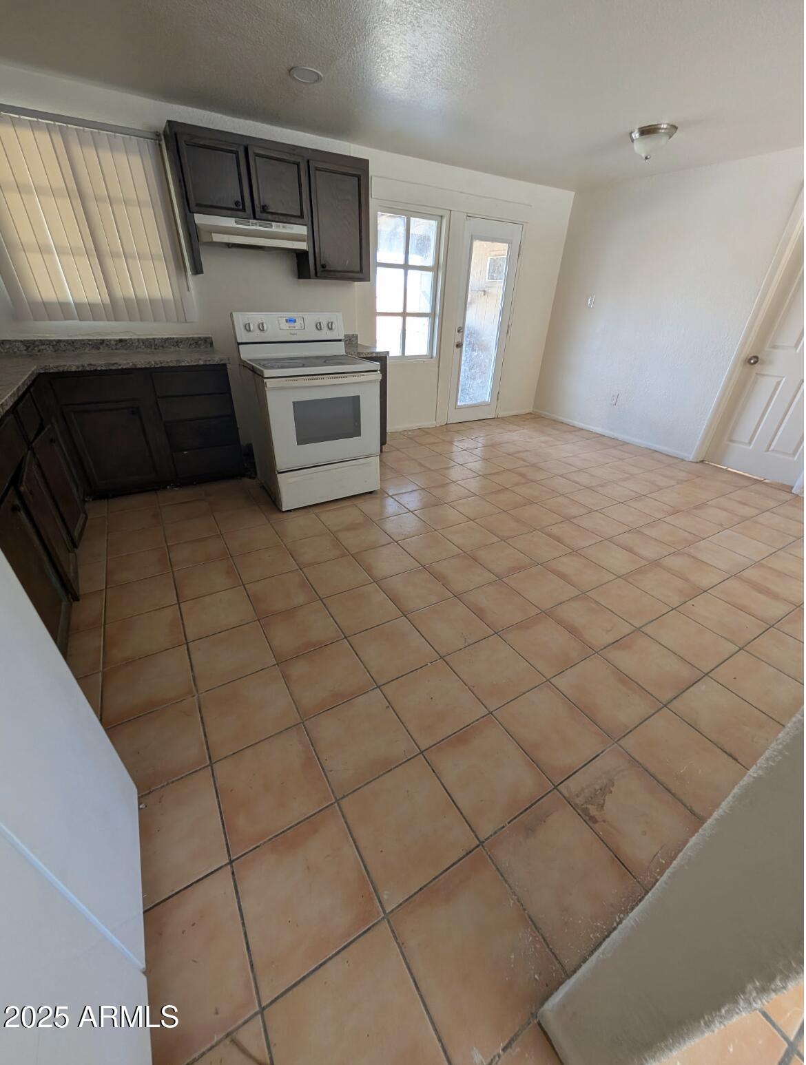 3302 East Thunderbird Road Phoenix, AZ 85032 - Photo 8 of 10 a kitchen with stainless steel appliances a stove a sink and a microwave
