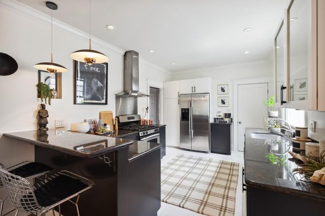 a kitchen with a stove and a sink