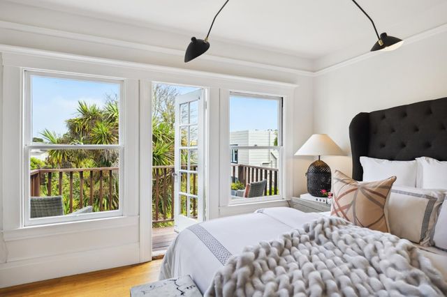 a bedroom with a bed and a painting on the wall