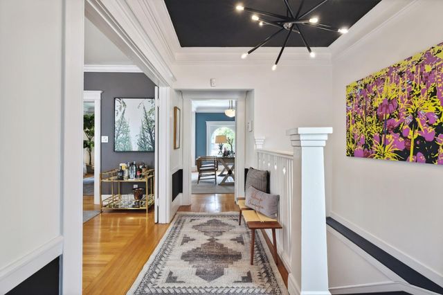 a very nice looking dining room with a fireplace and a chandelier