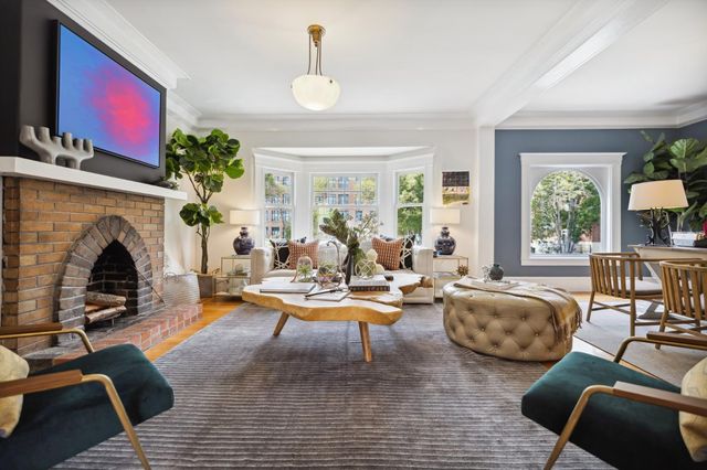 a living room with fireplace furniture and a fireplace