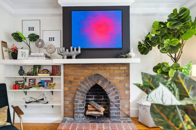 a living room with furniture and a potted plant