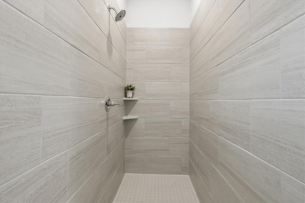 4017 Alpine Street Midlothian, TX 76065 - Photo 22 of 37 Walk-in shower featuring light-toned tile walls, a mosaic tile floor, and chrome fixtures