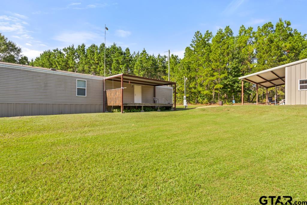 5379 County Road 385 Tyler, TX 75708 - Photo 40 of 44 a view of a house with a yard