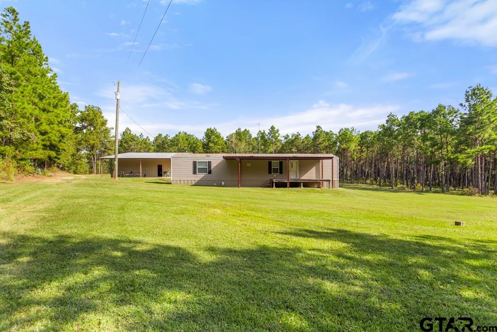 5379 County Road 385 Tyler, TX 75708 - Photo 7 of 44 a front view of a house with a garden