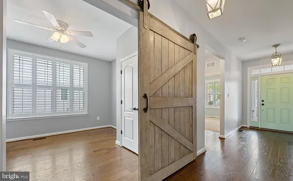 a view of hallway with stairs and wooden floor