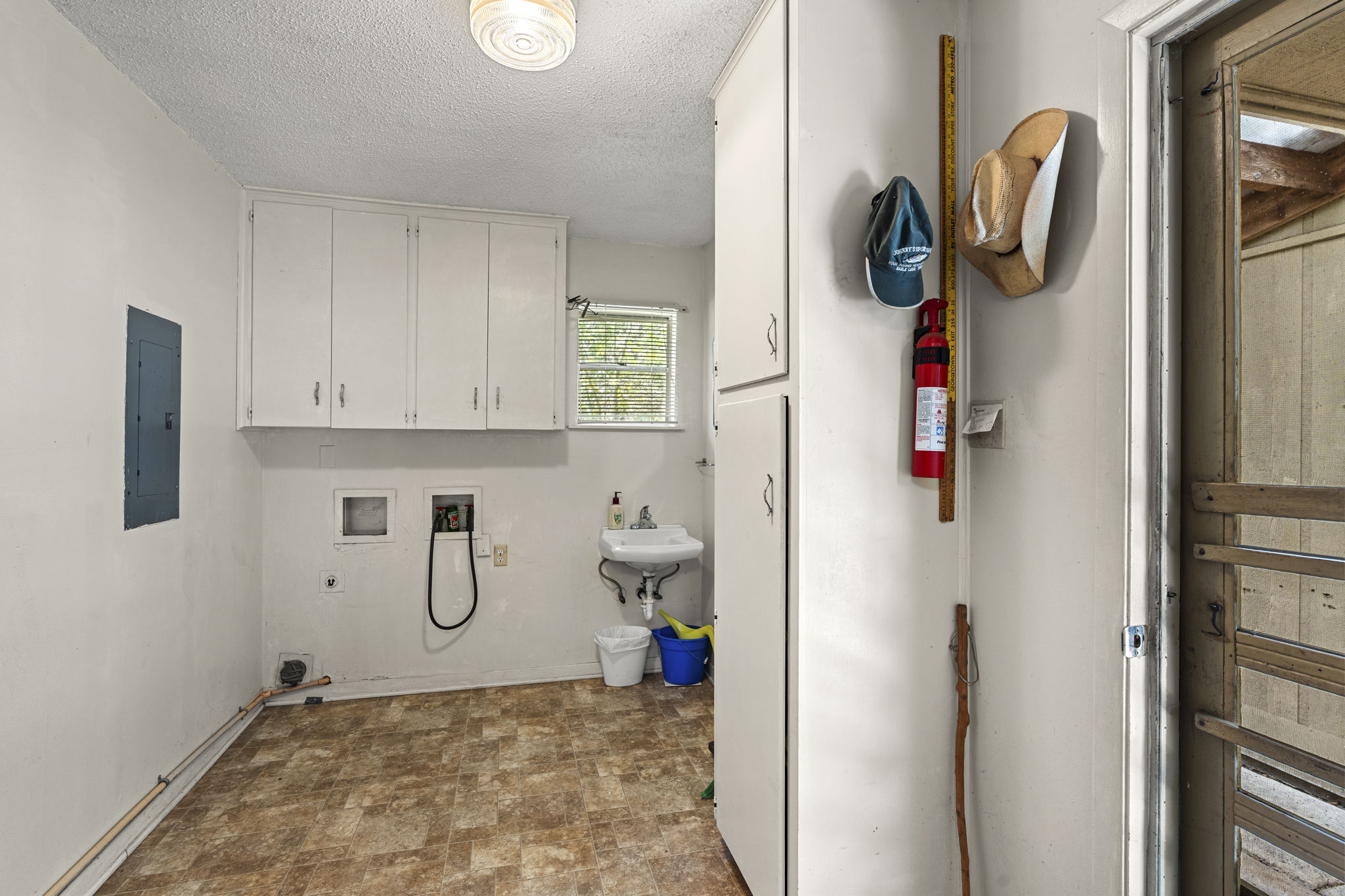 3511 Wyldwood Road Austin, TX 78739 - Photo 20 of 40 Washroom with cabinet space, washer hookup, hookup for an electric dryer, electric panel, and a textured ceiling