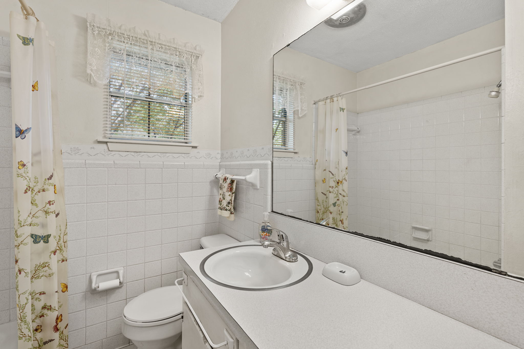 3511 Wyldwood Road Austin, TX 78739 - Photo 25 of 40 Bathroom featuring vanity, tile walls, a wainscoted wall, and a shower with curtain