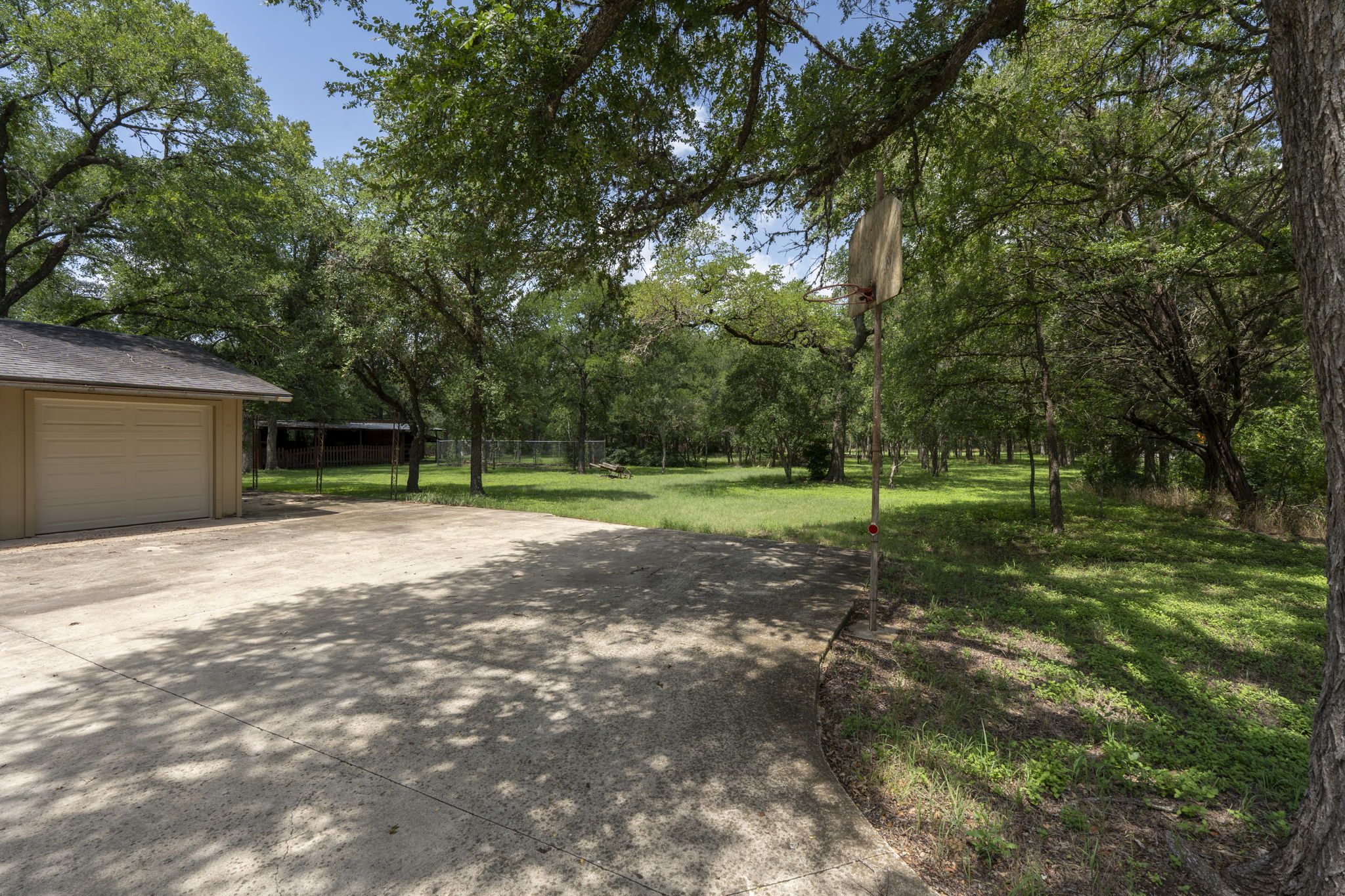 3511 Wyldwood Road Austin, TX 78739 - Photo 32 of 40 View of yard featuring driveway and a garage