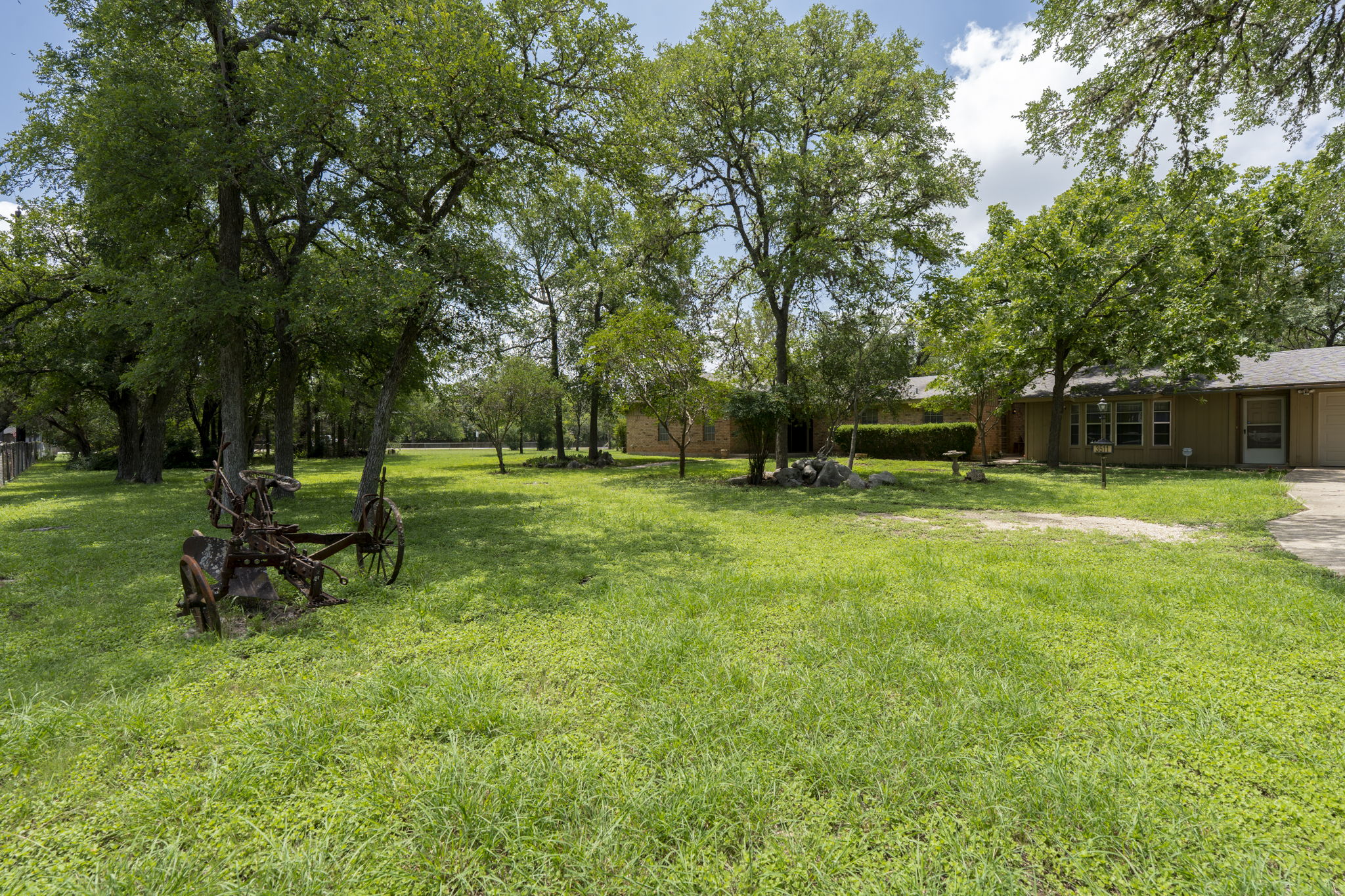 3511 Wyldwood Road Austin, TX 78739 - Photo 38 of 40 View of grassy yard with concrete driveway and an attached garage