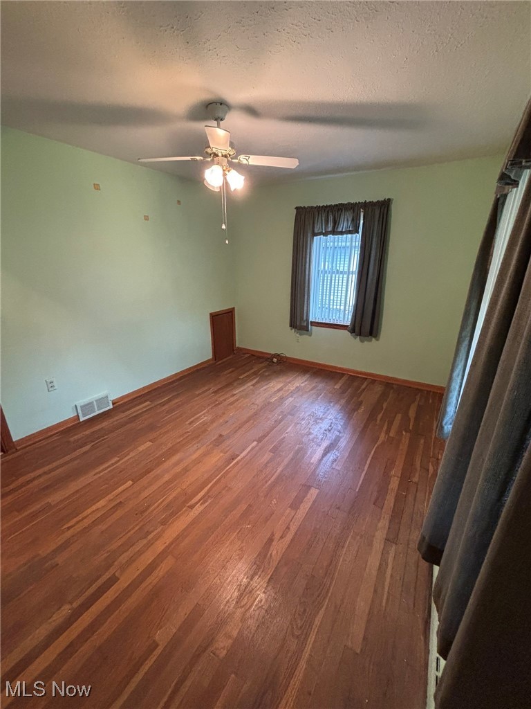 1039 Center Road Eastlake, OH 44095 - Photo 14 of 29 Largest bedroom featuring a ceiling fan and double closets.